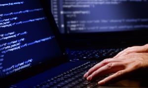 Hacker using a laptop running a computer programme