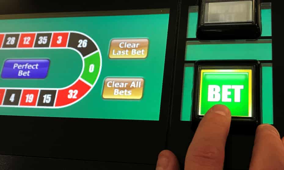 A man gambles on a betting terminal inside a bookmakers.