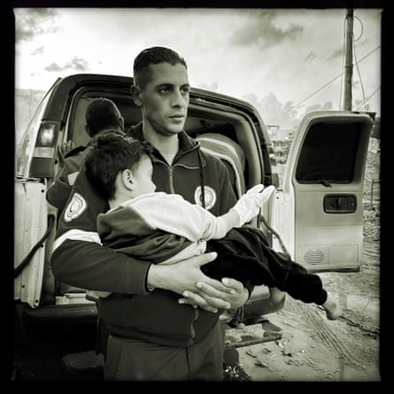 A PRCS paramedic carries a child