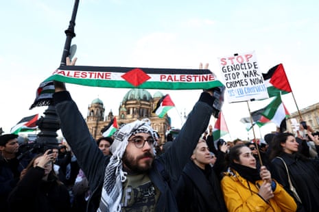 People hold banners at a pro-Palestinian demonstration in Berlin, Germany, 4 November 2023.