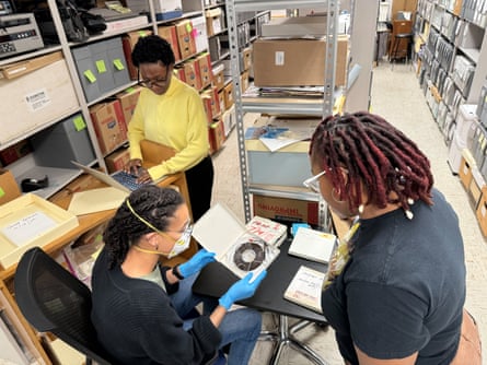 people looking through archival material