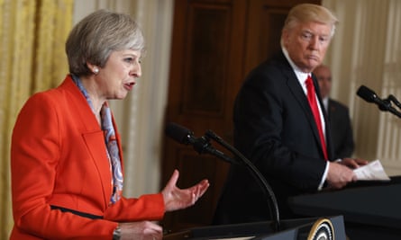 Donald Trump looks on as Theresa May