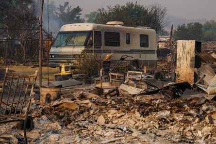 an RV is parked near burned out debris