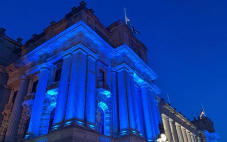 Victoria's parliament building lit up in blue