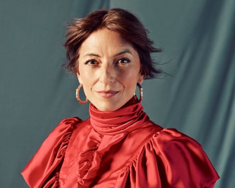 McCall in silky full-length red dress with ruffles across top