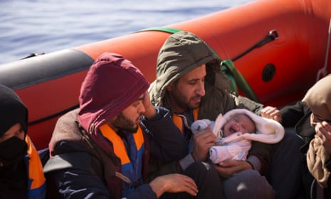 A two-month-old baby from Libya aboard a rubber rib after being rescued from a wooden boat sailing out of control about 18 miles north of Sabratha