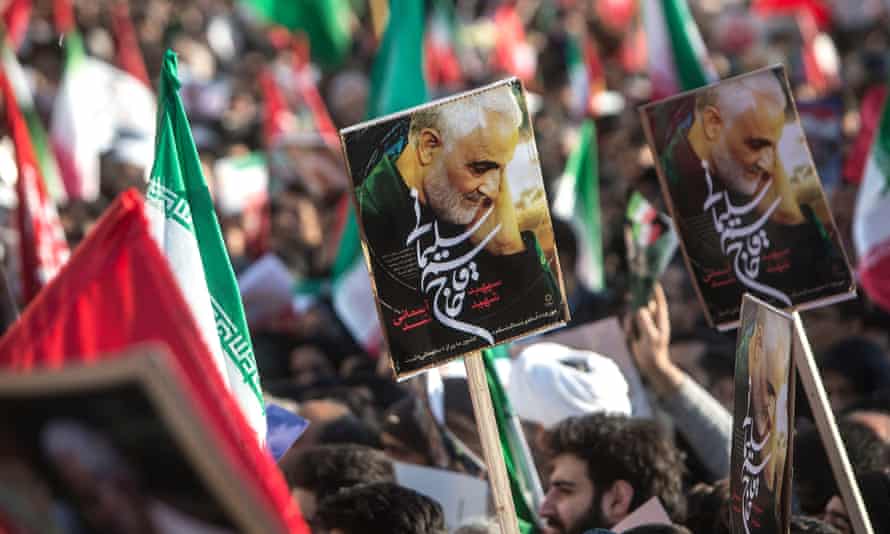 People hold posters during the funeral ceremony of Iranian general Qassem Suleimani in Tehran, Iran.