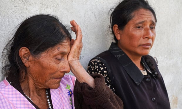 Tomasa and Petra Rodriguez, aunts of Javier Flores, who was found dehydrated in the tractor-trailer, wait for news of their nephew in San Miguel Huautla, in Oaxaca state, Mexico.