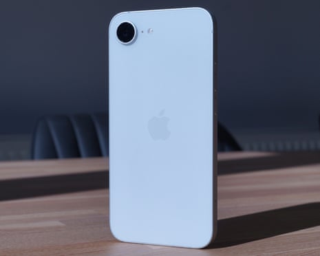 Apple iPhone 16e in white stood up showing the back glass.