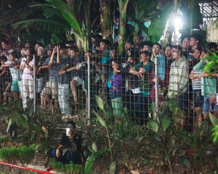 Throng of people watching after the trains collided