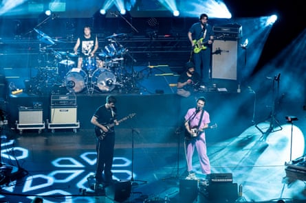 two men playing the guitar