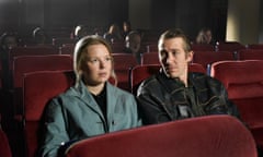 Alma Pöysti and Jussi Vatanen sit together in a cinema in Fallen Leaves.