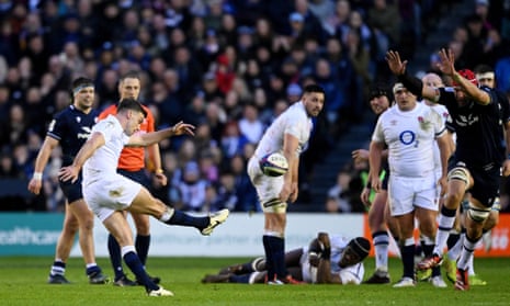 George Ford of England successfully kicks a drop goal whilst under pressure from Grant Gilchrist of Scotland.