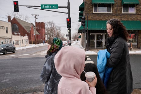 A woman walks with children