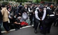 Police arrest people protesting against migrants being removed from a hotel in Peckham, south London, on 2 May.