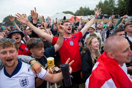 Fans cheer on the Three Lions while watching the game at the festival.