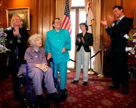 Gavin Newsom and two women clap while looking at Phyllis Lyon, 84, and Del Martin, 87, who is in a wheelchair, before a ceremony at City Hall in San Francisco