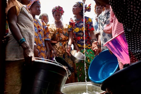 Fulani women wait their turn to retrieve a bucket of water in an internally displaced people’s camp on the outskirts of Bamako, Mali.