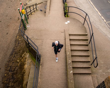 Kieran Alger running next to some stairs