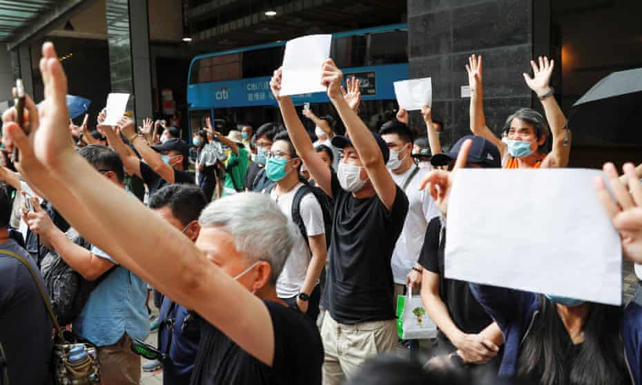 Hongkongers raise blank papers after slogans were banned.