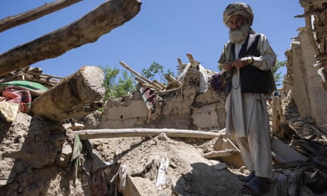 Abdullah Abed, 65, stands outside his house in Gayan, Afghanistan, where he lost two of his children.