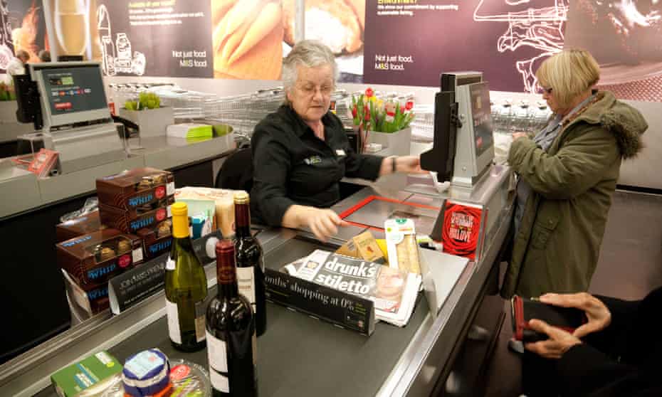 People paying for food at the checkout in a Marks and Spencer store