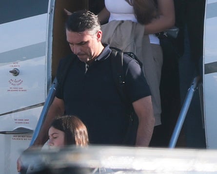 Flavio Bolsonaro descends aircraft steps with a backpack