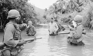 US troops move South Vietnam suspects across a stream, October 1966
