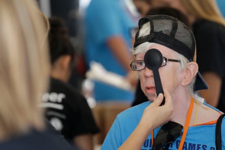 An athlete gets a free eye exam in “olympic town” at the Indiana Special Olympics.