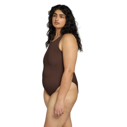 A model wears a You swim Elan One-Piece brown swimsuit