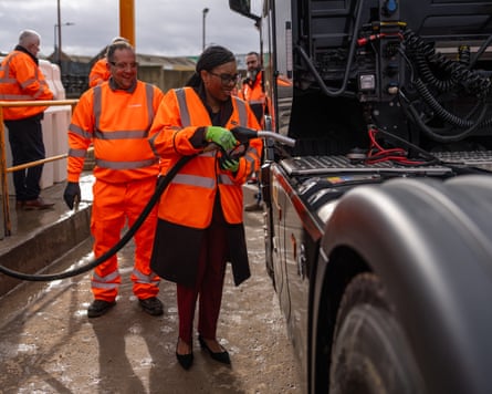 Conservative leader Kemi Badenoch poses for the media as she fills a lorry with diesel during a visit to Flannery Plant Hire in Wembley, England