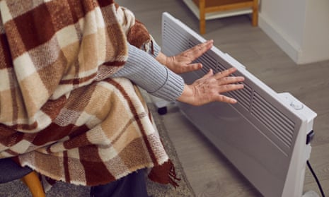 Elderly man at home with blanket and heater