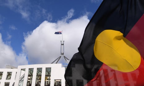 Australian parliament behind an Aboriginal flag