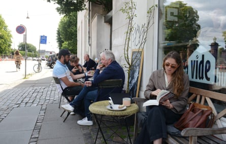 Customers on tables outside Det Vide Hus on Gothersgade, Copenhagen.