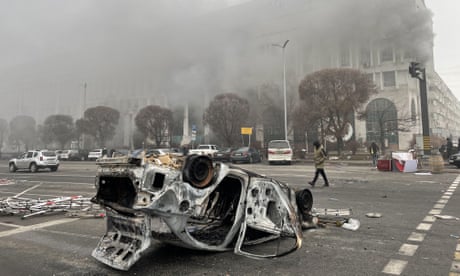 A burnt out vehicle in Republic Square, Almaty.
