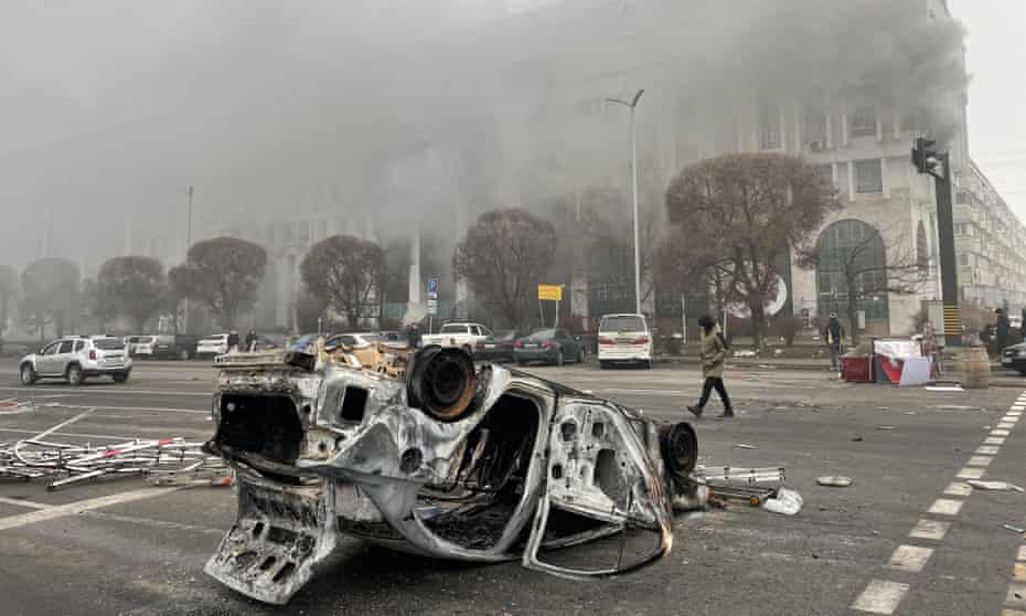 A burnt out vehicle in Republic Square, Almaty.