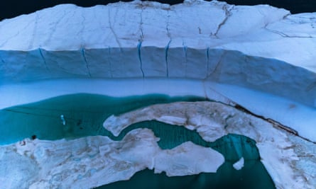Baffin Bay, a melting pond in an iceberg, was seen on July 20, 2022.  Over the past 20 years, the Arctic has lost about a third of its winter sea ice volume.