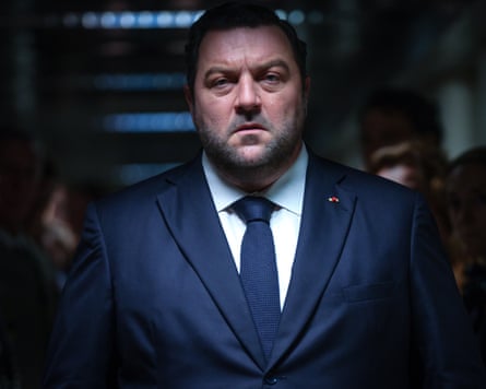 Denis Ménochet in a suit in a still from Jupiter