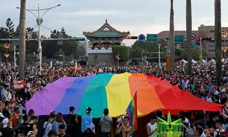Participants hold a giant rainbow flag as they take part in LGBT pride parade in Taipei in 2017 