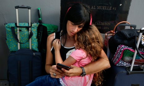 Solymlar Duprey holds her daughter Miabella as they try to get on an evacuation cruise ship leaving San Juan.
