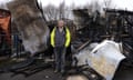 Luke Evans stands among the burned remains of his research facility