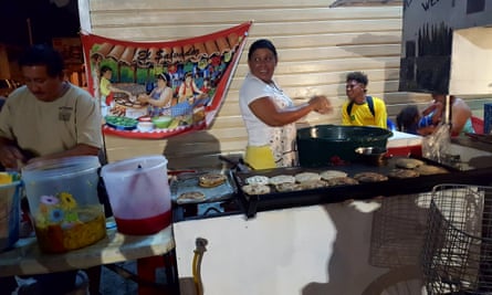 The busiest nighttime food stall near the swing bridge in Belize City is run by a Salavdoran couple making the national dish, pupusas.