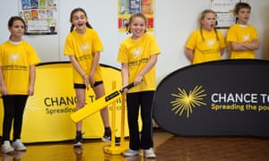 Young children playing indoor cricket