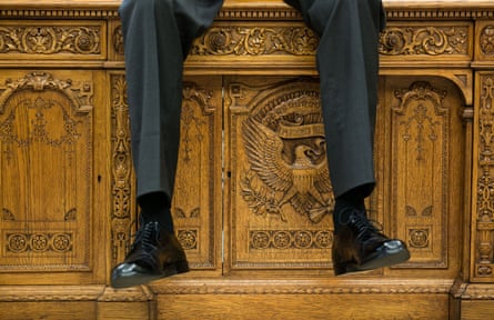 Seat of power … Barack Obama uses the Resolute desk to take the weight off.