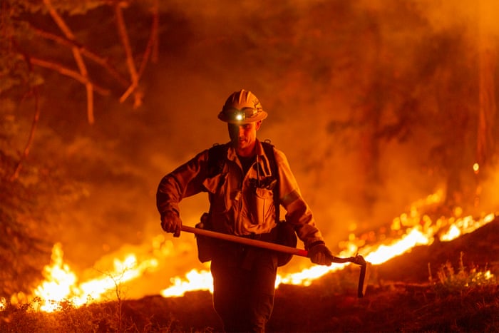 Los Angeles County firefighters, using only hand tools, keep fire from jumping a fire break at the Bobcat Fire in the Angeles National Forest on 11 September, 2020 north of Monrovia, California. California wildfires have already incinerated a record 2.3 million acres this year and are expected to continue till December. The Bobcat Fire has grown to more than 26,000 acres.