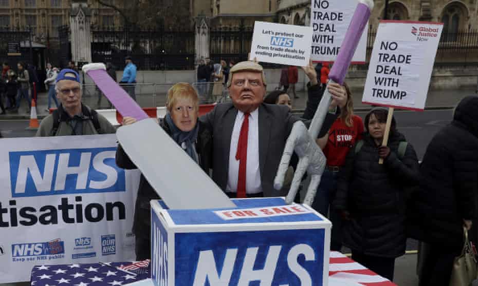 NHS campaigners with masks of Boris Johnson and Donald Trump take part in a demonstration on Parliament Square