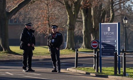 Police officers stand guard inside Epsom College