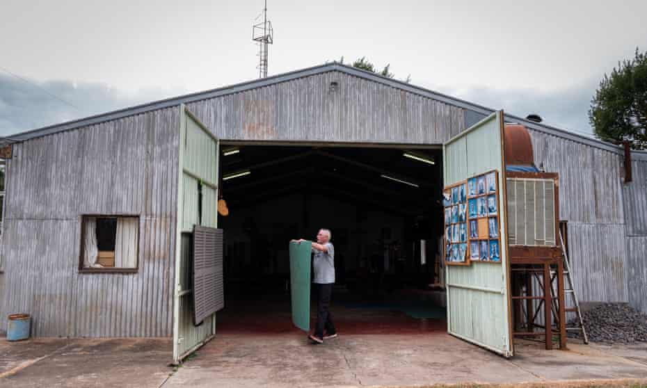 Peter Hill, removes rubber flooring on his shed floor to convert his gym into a line dancing studio.