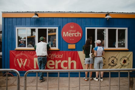 People stand at a merch booth
