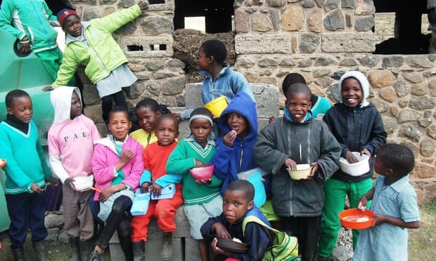 Pupils at Semonkong African Methodist episcopal primary school in Lesotho eat a lunch provided by the World Food Programme